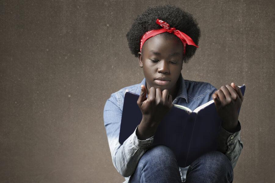 African-American girl reading a book