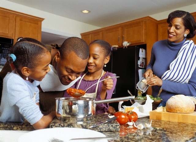 Black family in the kitchen back in June 2013 [Press Photo]